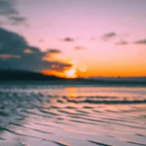 Calm ocean horizon at sunset with soft pastel colors